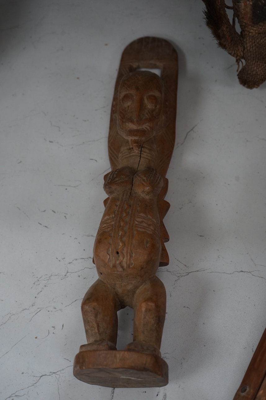 A Papua New Guinea ceremonial bone dagger, a painted straw mask, a tribal instrument and a carved stool. Condition - fair/good